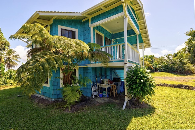 rear view of property with a yard