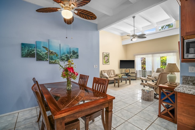 tiled dining room with beam ceiling and ceiling fan