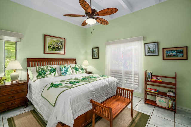 tiled bedroom featuring beamed ceiling and ceiling fan