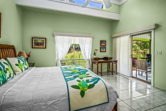 tiled bedroom featuring a high ceiling, access to outside, and multiple windows