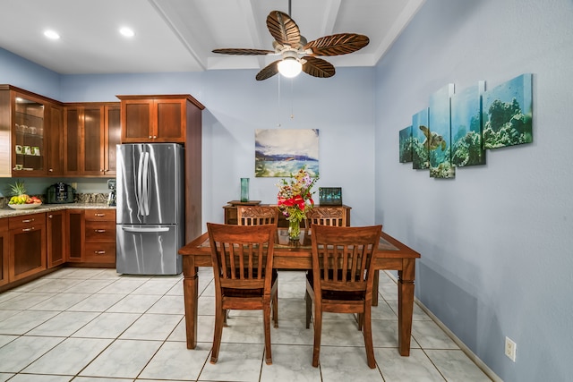 dining space featuring beam ceiling, ceiling fan, and light tile flooring