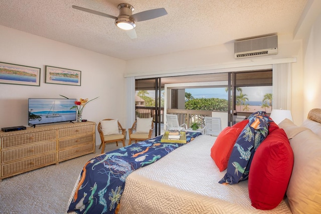 bedroom featuring a wall mounted air conditioner, ceiling fan, access to exterior, and a textured ceiling