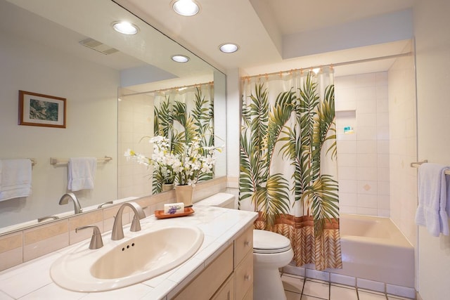 full bathroom featuring tile patterned floors, shower / bath combo with shower curtain, vanity, and toilet