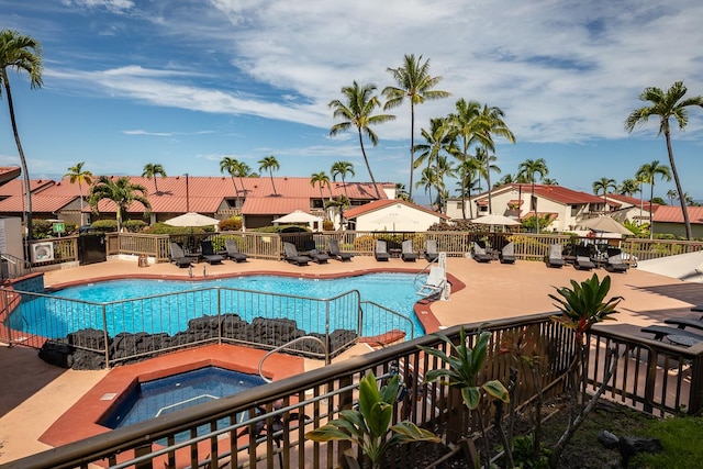 view of swimming pool featuring a patio area and a community hot tub