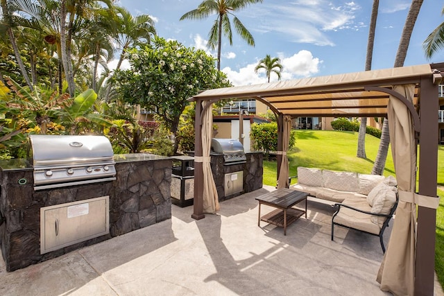 view of patio with area for grilling, a grill, and outdoor lounge area