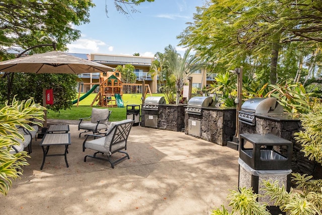 view of patio with a playground and area for grilling