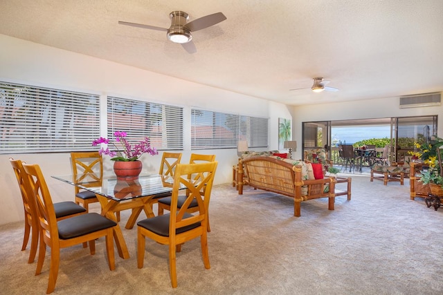 carpeted dining room featuring a textured ceiling and ceiling fan