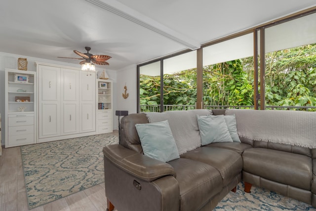 living room with ceiling fan, floor to ceiling windows, light wood-type flooring, and ornamental molding