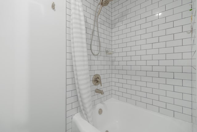 bathroom with shower / tub combo with curtain