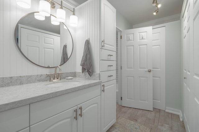 bathroom featuring vanity and crown molding