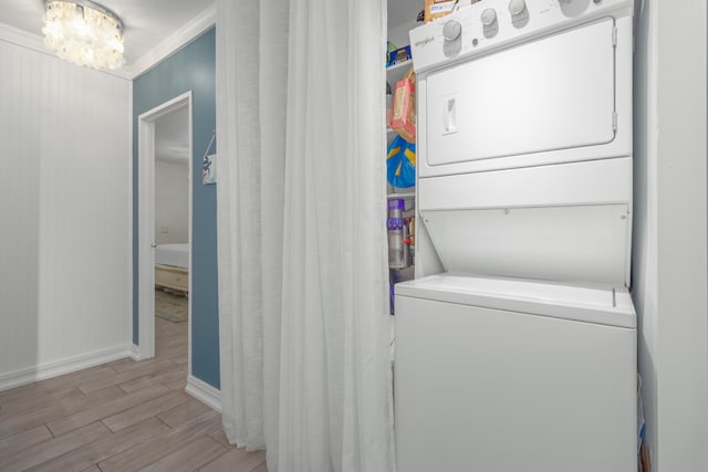 laundry area with stacked washer and dryer