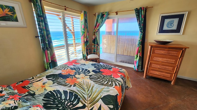 bedroom featuring access to outside, a water view, and baseboards