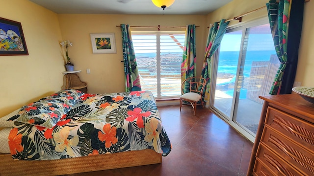 bedroom featuring access to exterior and a water view