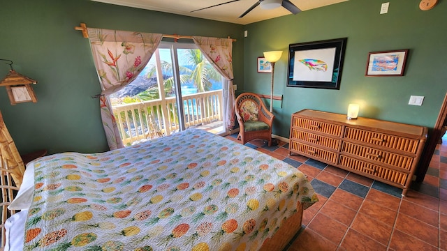 bedroom featuring dark tile patterned floors, a ceiling fan, and access to exterior