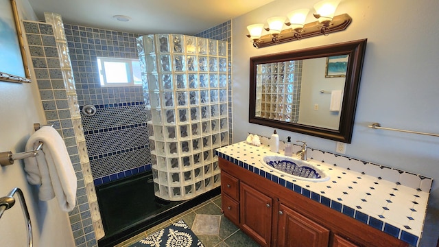 full bathroom featuring tile patterned flooring, vanity, and walk in shower