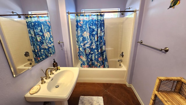 bathroom featuring tile patterned flooring, a sink, shower / bathtub combination with curtain, and baseboards