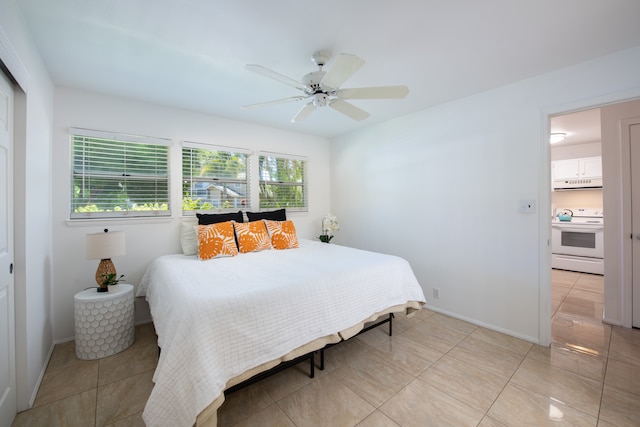 tiled bedroom featuring ceiling fan and a closet