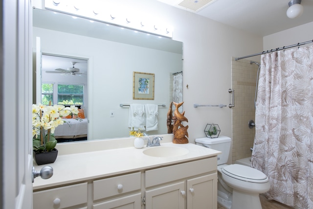 full bathroom featuring shower / bathtub combination with curtain, ceiling fan, vanity, and toilet