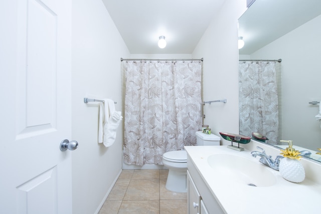 bathroom featuring tile patterned flooring, vanity, and toilet