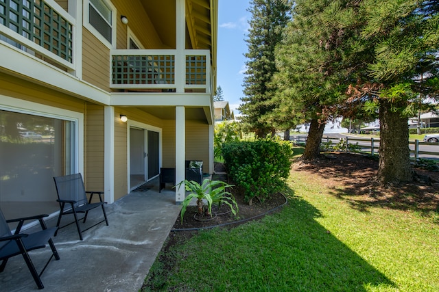 view of yard featuring a patio area and a balcony