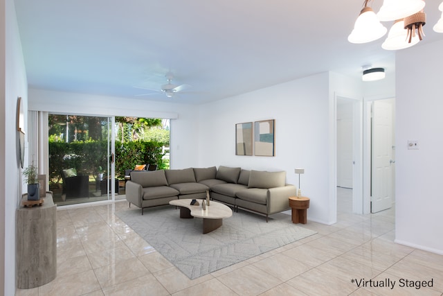 living room featuring ceiling fan with notable chandelier