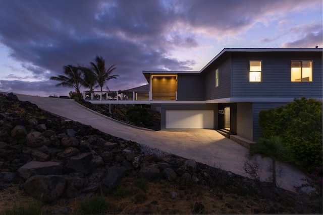 back house at dusk with a garage