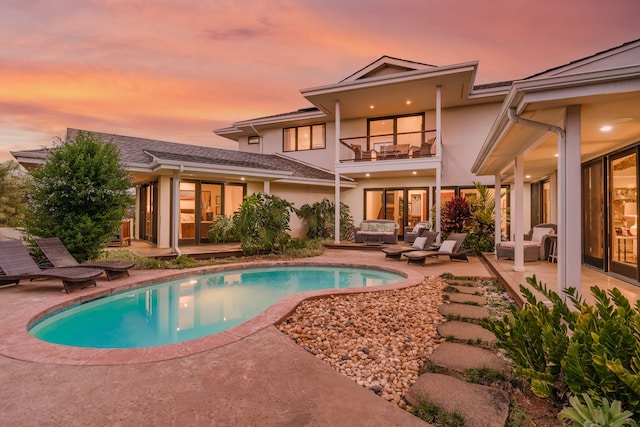 exterior space featuring a patio area, an outdoor living space, and a balcony