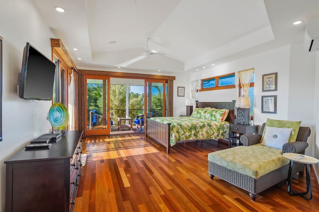 bedroom featuring wood-type flooring, ceiling fan, a raised ceiling, and access to outside