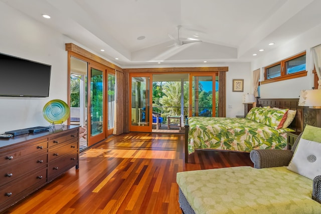 bedroom with access to exterior, ceiling fan, a raised ceiling, dark wood-type flooring, and lofted ceiling