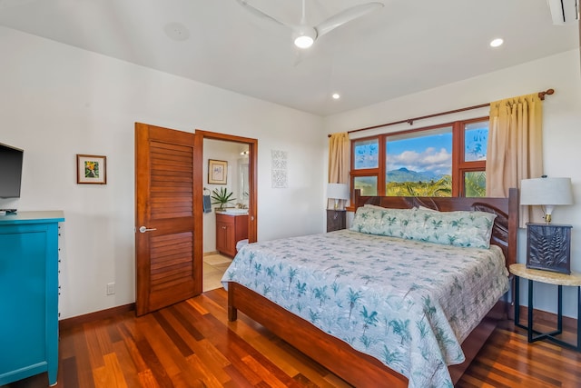 bedroom featuring dark wood-type flooring, ensuite bath, and ceiling fan