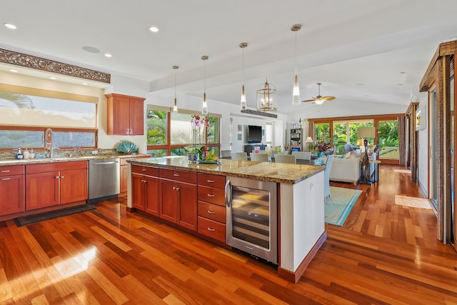 kitchen featuring lofted ceiling, hardwood / wood-style floors, decorative light fixtures, wine cooler, and dishwasher