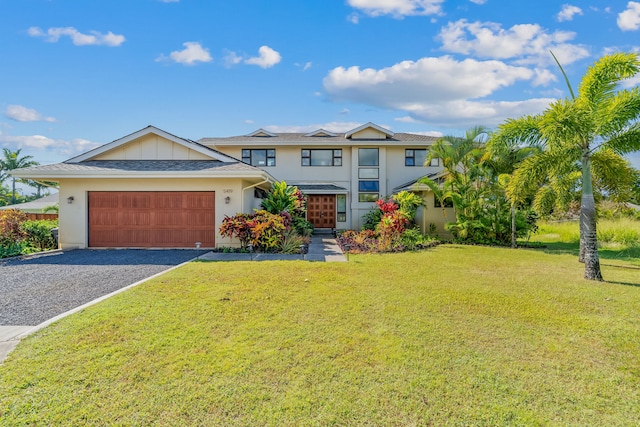 view of front of property with a front lawn and a garage