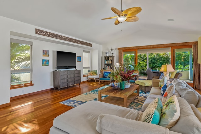 living room with hardwood / wood-style flooring, ceiling fan, and vaulted ceiling