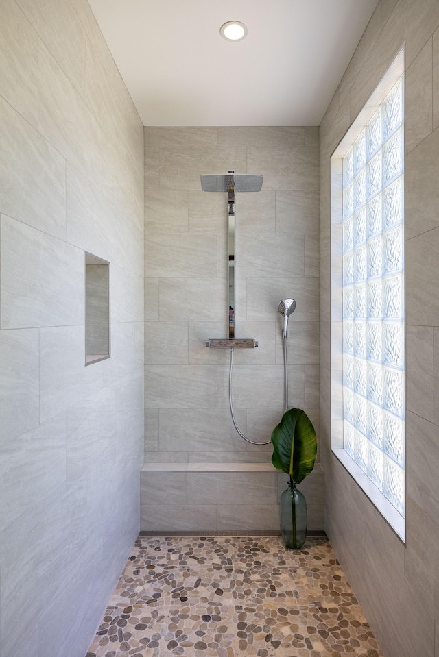 bathroom with tiled shower