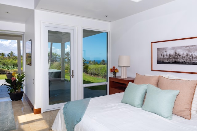 bedroom featuring access to exterior and light tile patterned floors