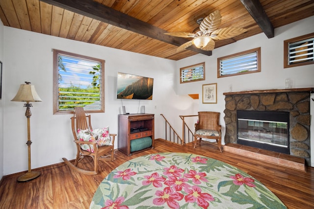 living room with beam ceiling, a stone fireplace, wooden ceiling, and hardwood / wood-style flooring