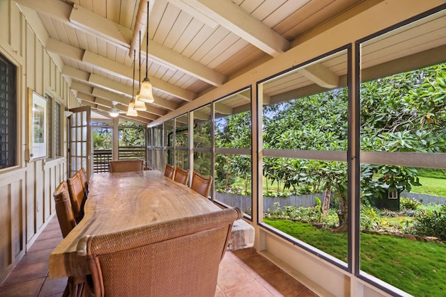 unfurnished sunroom featuring vaulted ceiling with beams and wooden ceiling