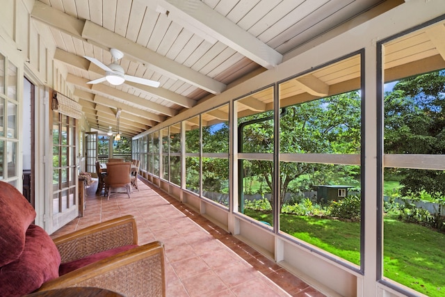 sunroom featuring vaulted ceiling with beams, ceiling fan, and wood ceiling