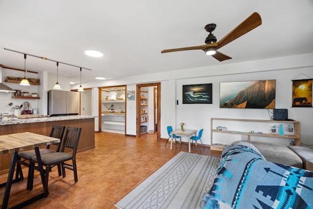 tiled living room featuring ceiling fan