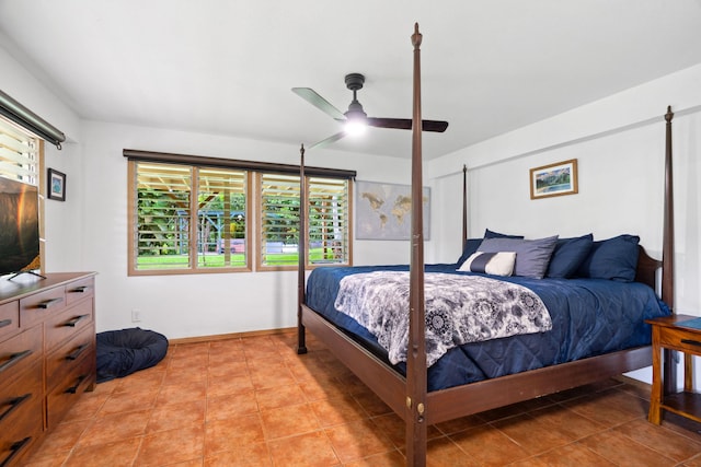 tiled bedroom featuring ceiling fan