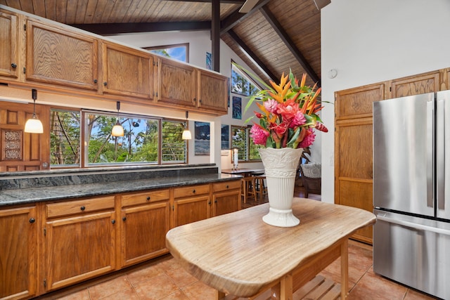 kitchen with stainless steel fridge, wood ceiling, beam ceiling, high vaulted ceiling, and hanging light fixtures