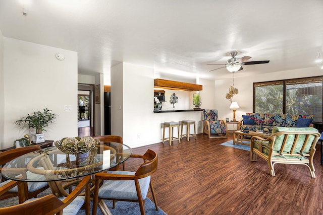 dining space featuring ceiling fan and dark wood-type flooring