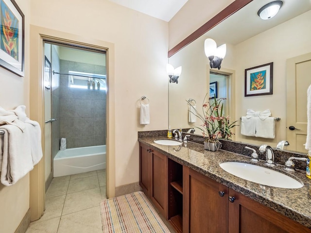 bathroom featuring tile patterned flooring, vanity, and tiled shower / bath