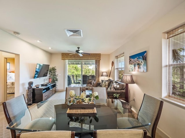 carpeted dining room featuring ceiling fan