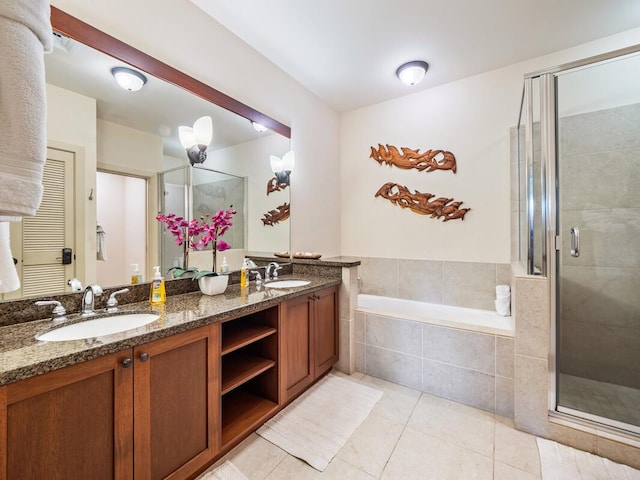 bathroom featuring tile patterned floors, vanity, and shower with separate bathtub