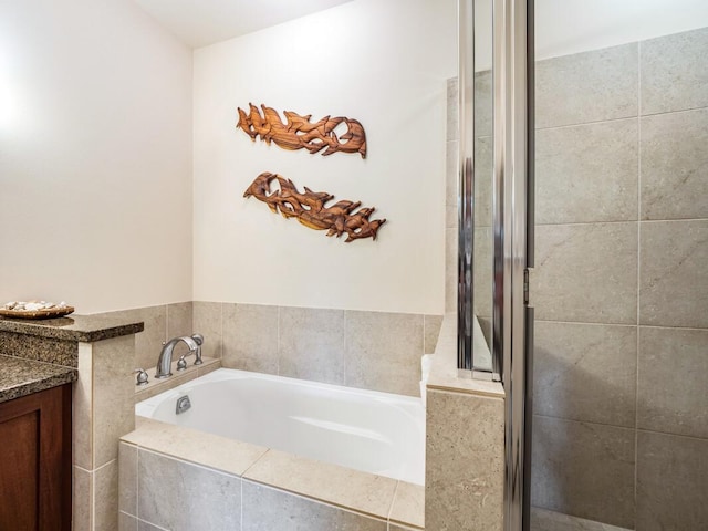 bathroom featuring vanity and plus walk in shower