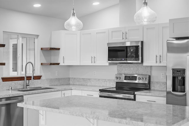 kitchen with pendant lighting, white cabinets, sink, light stone countertops, and stainless steel appliances