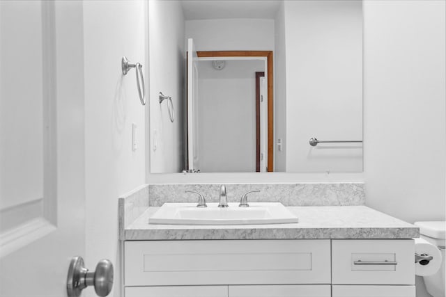 bathroom featuring vanity and toilet