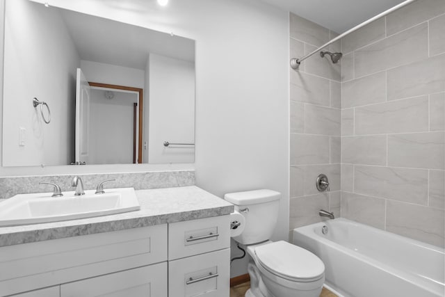 full bathroom featuring vanity, toilet, and tiled shower / bath