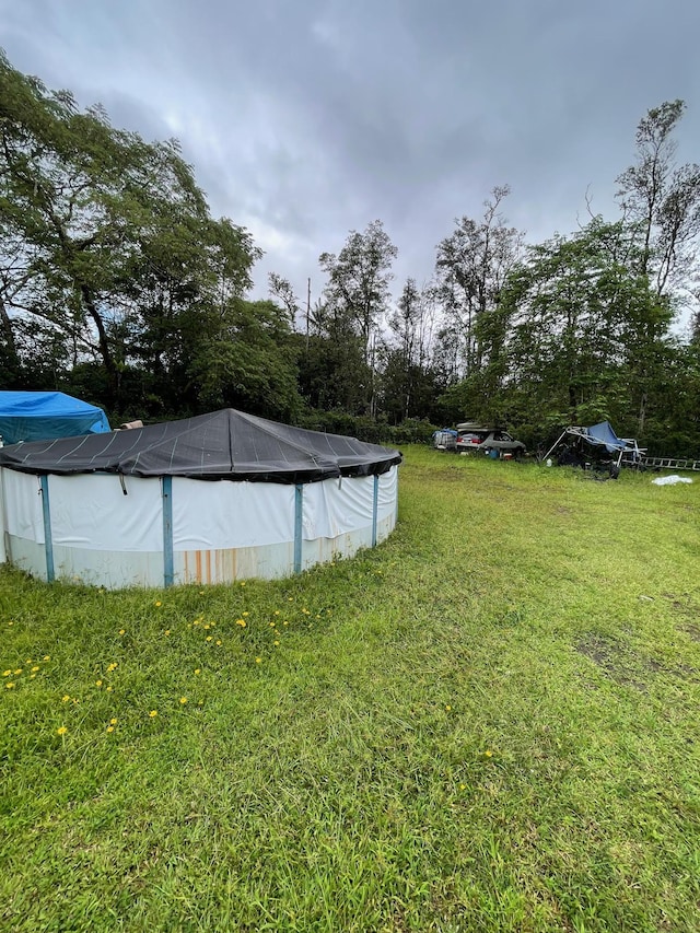 view of yard featuring a covered pool